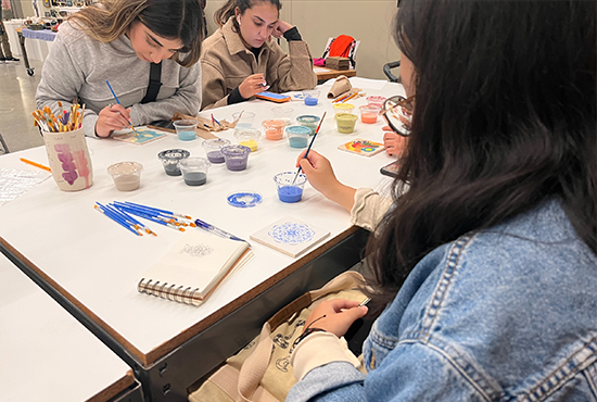 students painting during ceramic tile glazing activity